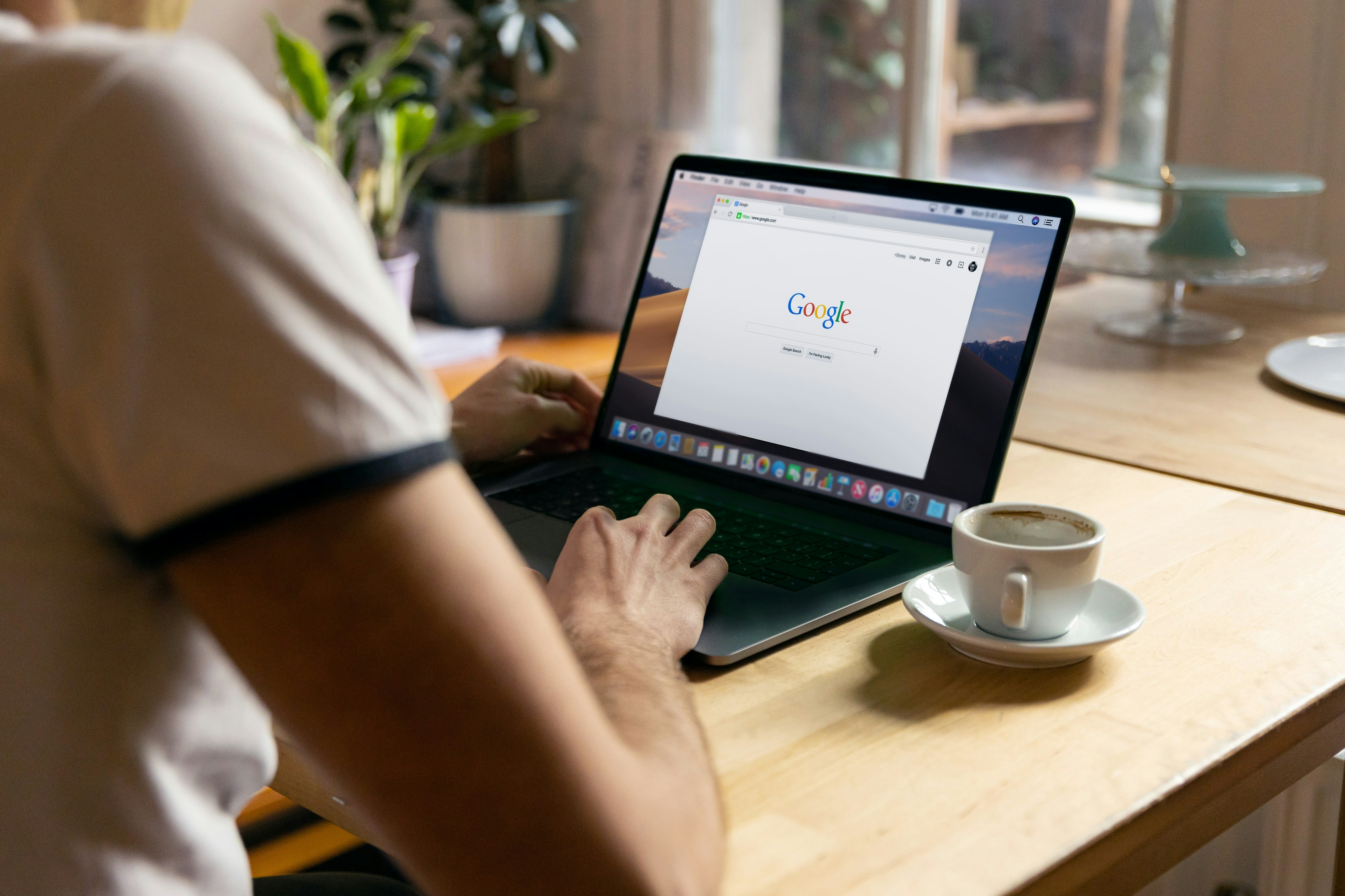 Man sitting on a Laptop with Google open